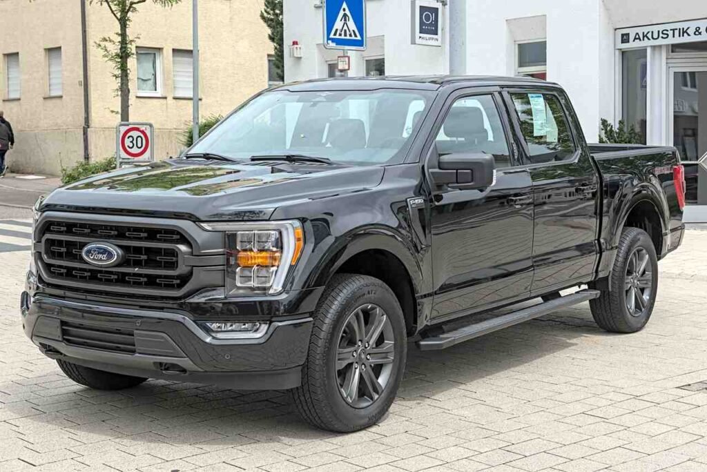 Fourteenth-generation Ford F-150 pickup truck in black, front three-quarter view